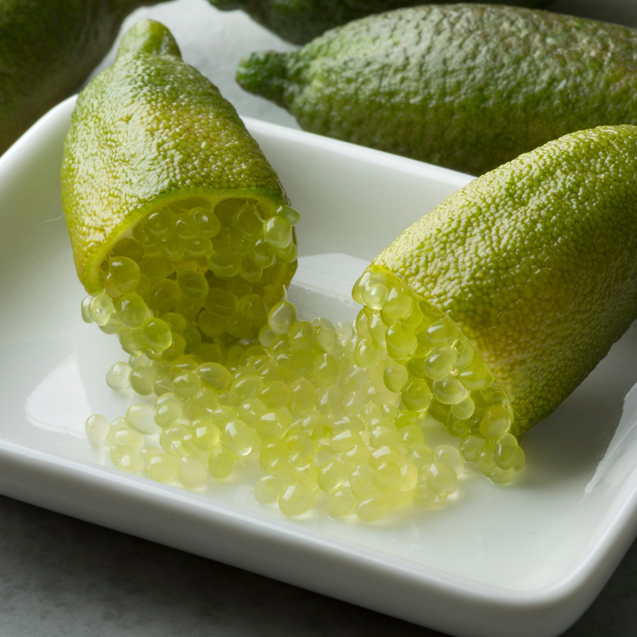 Dettaglio di limone caviale verde con forma allungata tagliato a metà